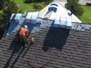 Closeup installation of new heather roof shingles on residential home