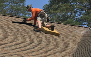 person inspection a roof